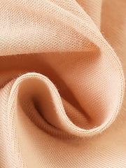 Girls' cotton undershirt in peach with a soft knit texture and ruffled sleeve detail.