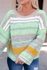 Open-shoulder knit pullover with horizontal stripes in green, white, grey, and yellow.
