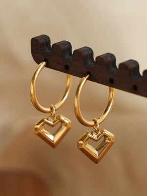 Gold hoop earrings with geometric heart charms
