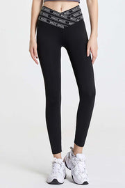 Black Angel Band active leggings with V-waistband and white logo detail.