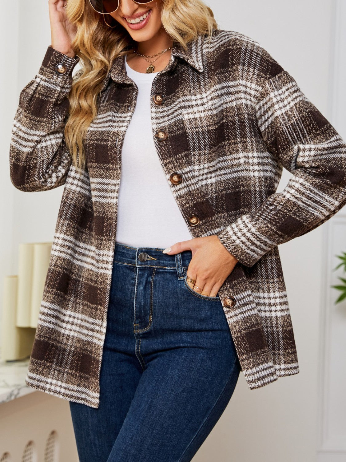 Brown plaid shacket with oversized buttons and a collared neckline.