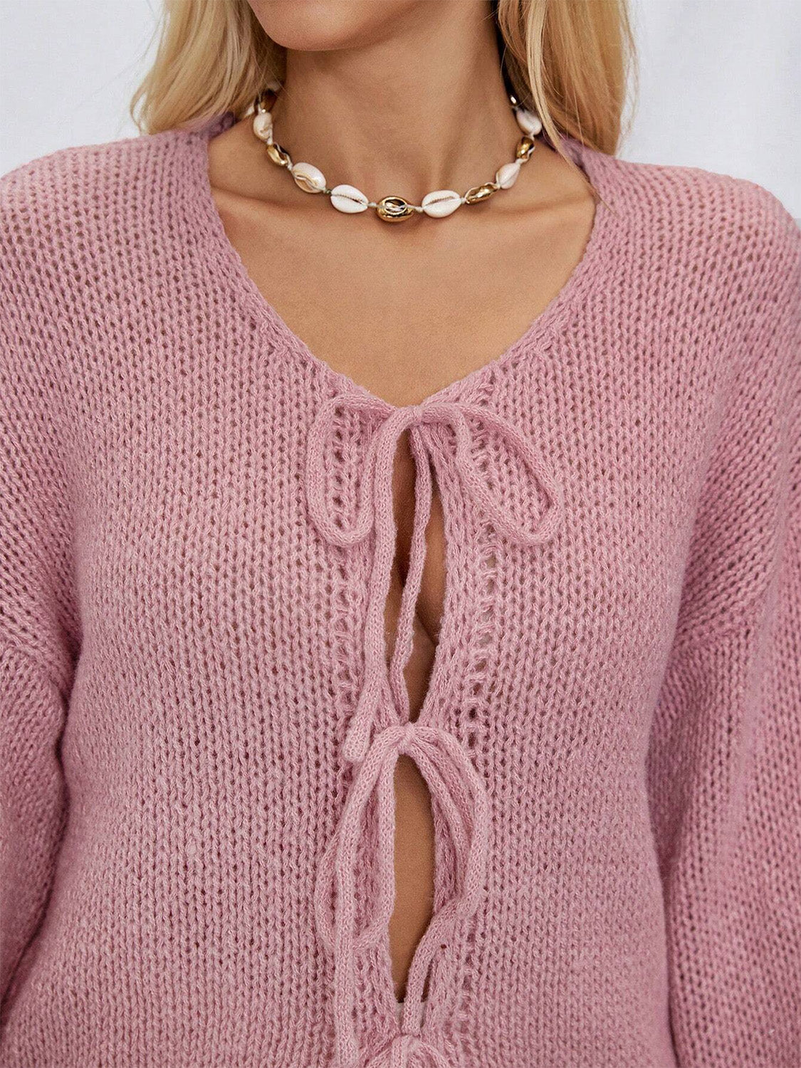 Dusty pink knit cardigan with V-neck and tie closure, featuring balloon sleeves.