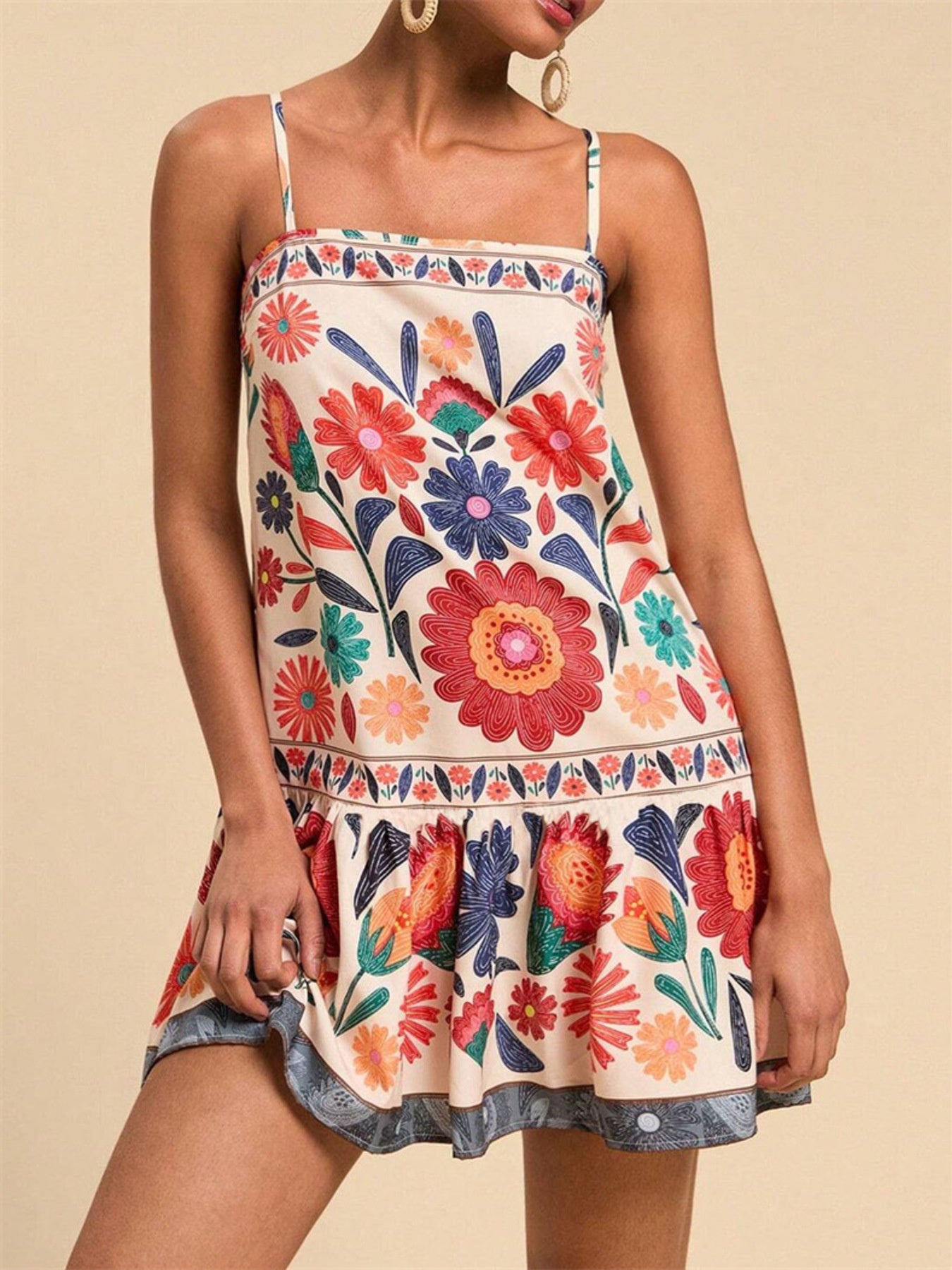 Playful printed mini dress with spaghetti straps and a ruffled hem.