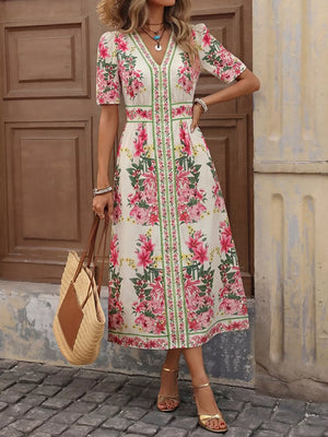 Charming floral V-neck midi dress with defined waist and short sleeves.