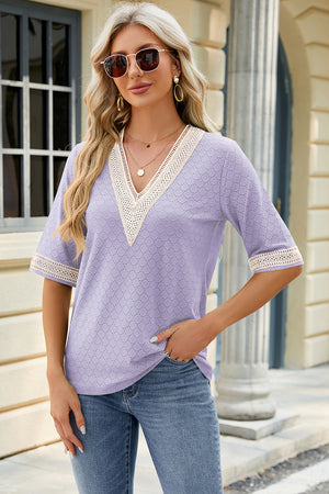 Lavender textured V-neck top with lace trim on neckline and sleeves