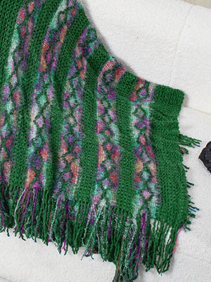 Dark green knit cape with diamond pattern and fringe detail
