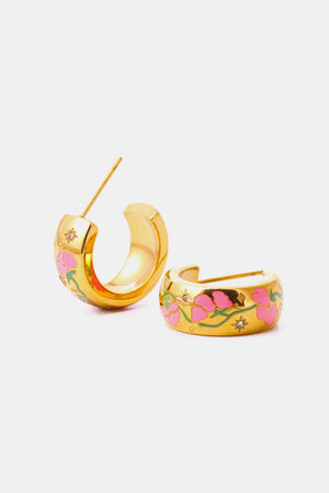 Gold hoop earrings with pink floral enamel and small crystal accents.