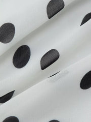 White mini dress with black polka dots and ruched detail