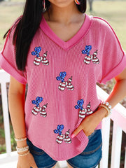 Pink striped V-neck tee with patriotic sequin balloon dog graphic and cuffed sleeves.
