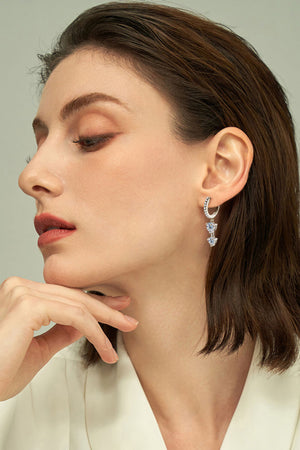 Silver hoop earrings with cascading moissanite drop charms.