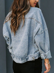 Denim jacket with leopard print panels on shoulders, light wash, relaxed fit.