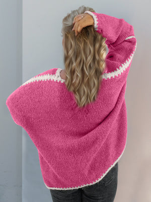 Pink oversized knit cardigan with white contrast stitch detail on neckline and sleeves