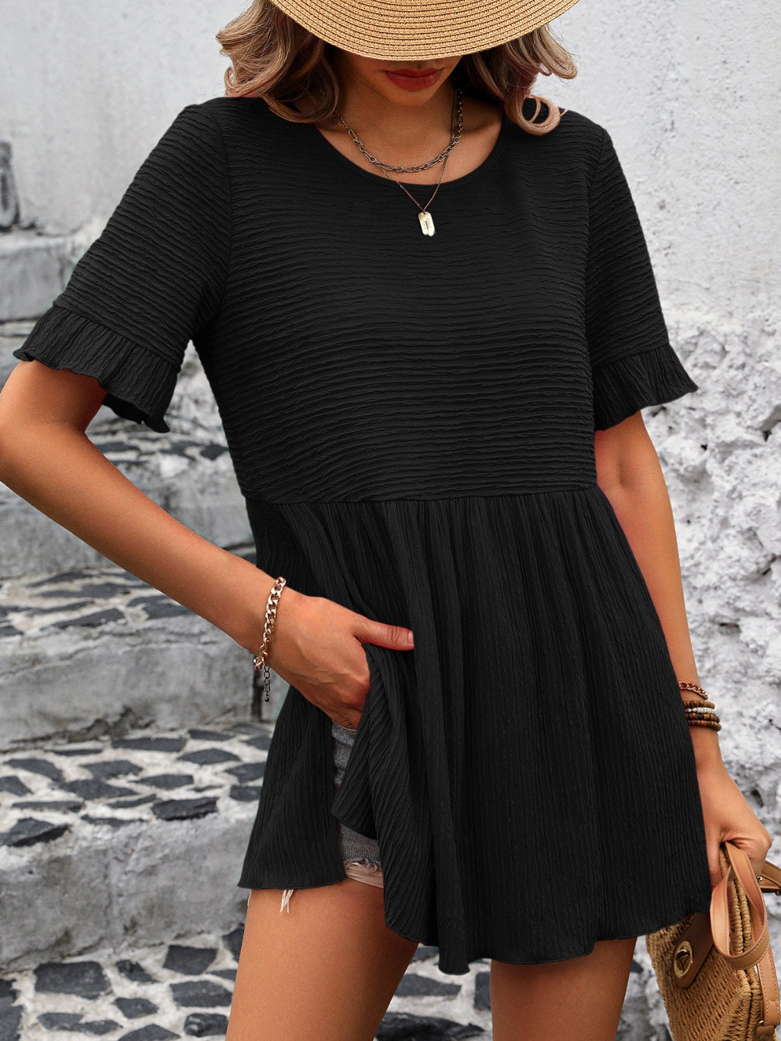 Black textured babydoll blouse with flutter sleeves and a tiered skirt.