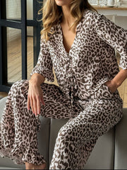 Print two-piece pajama set with animal print, V-neck, tie waist, and ruffled sleeves and hem.