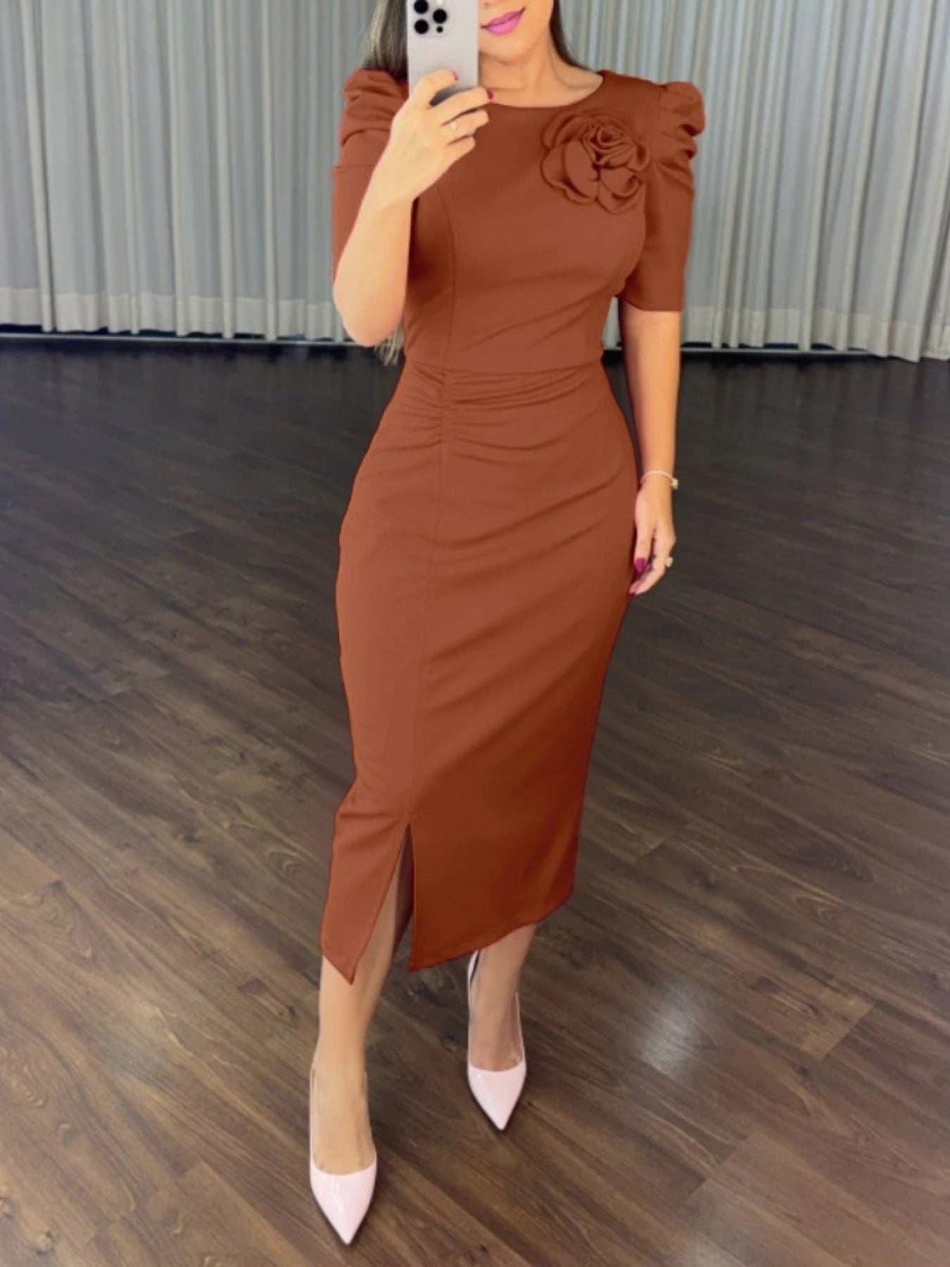 Brown bodycon midi dress with floral detail, ruched sides, and a slit.