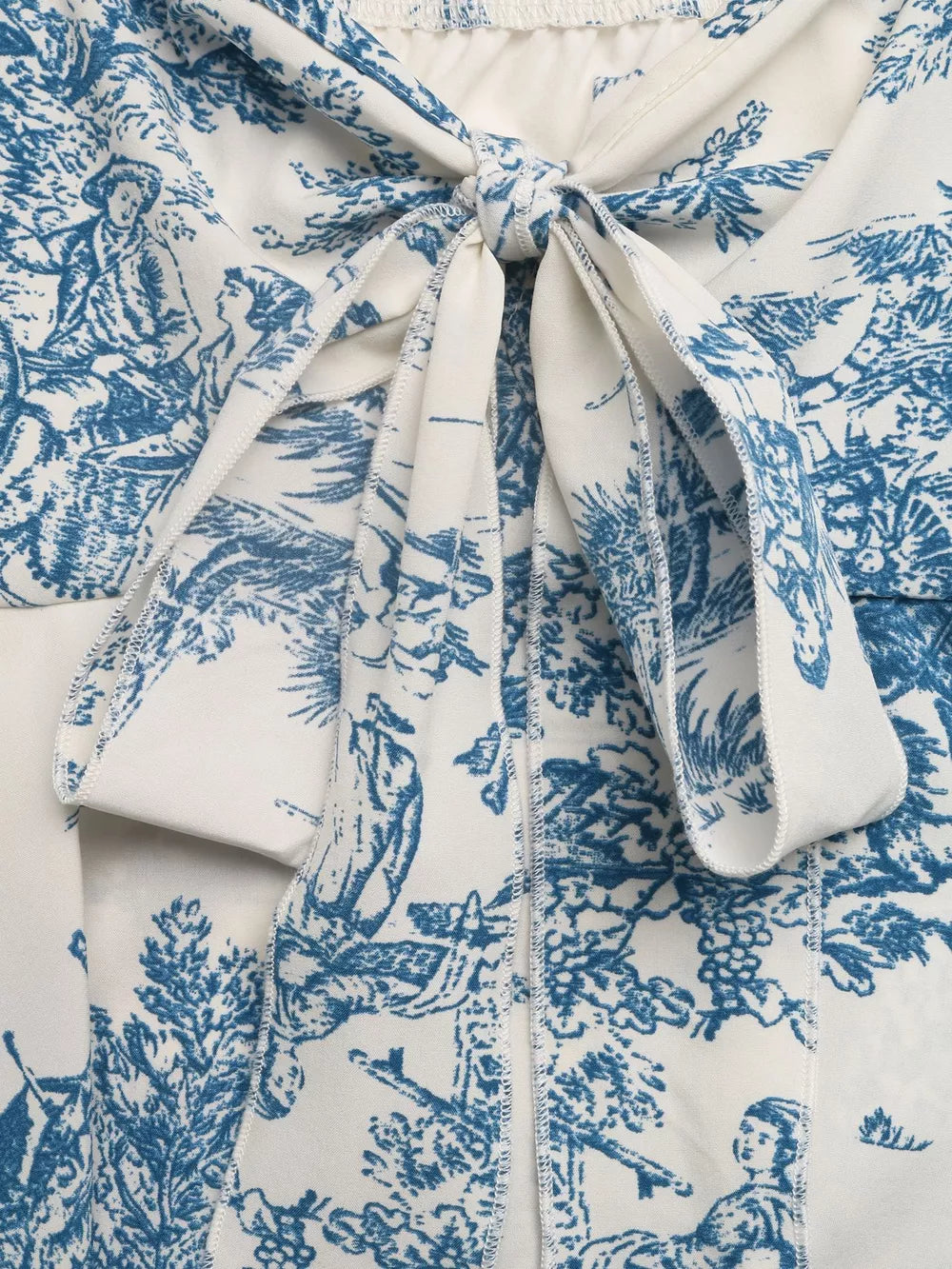 Charming floral tie-front cami top in blue and white toile print with tie detail.