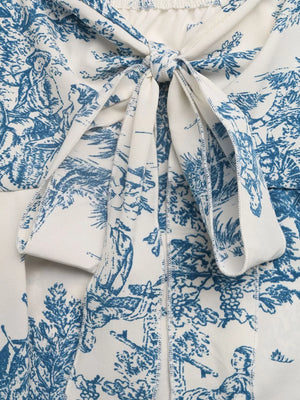 Charming floral tie-front cami top in blue and white toile print with tie detail.