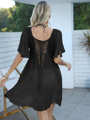 Black crochet inset beach cover-up dress with flutter sleeves and A-line skirt.