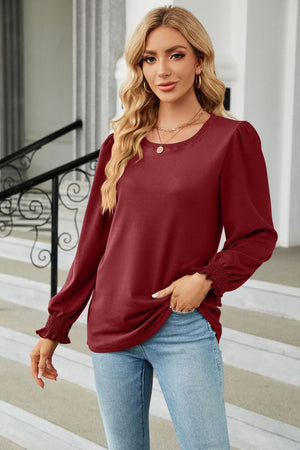 Crimson ribbed cuff top with puff sleeves and a round neckline.