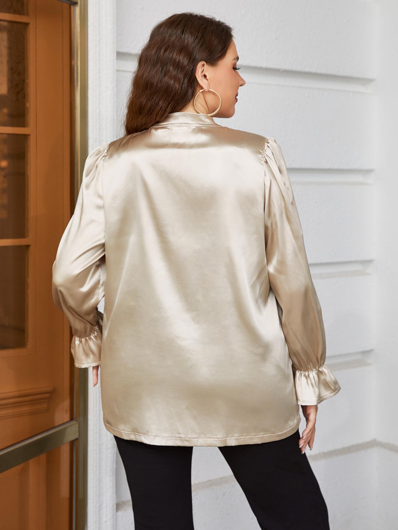 Gold satin blouse with mandarin collar, ruffles on cuffs and shoulders.