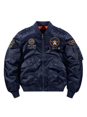 Men's blue zip up bomber jacket with patches and utility sleeve pocket.