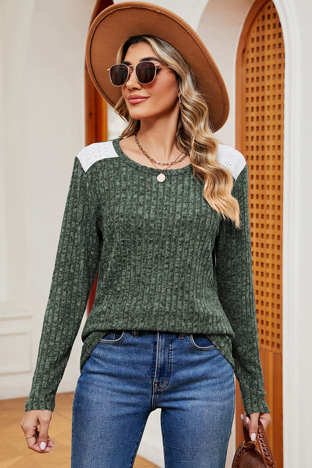 Green ribbed knit top with eyelet shoulder detail and crew neck.