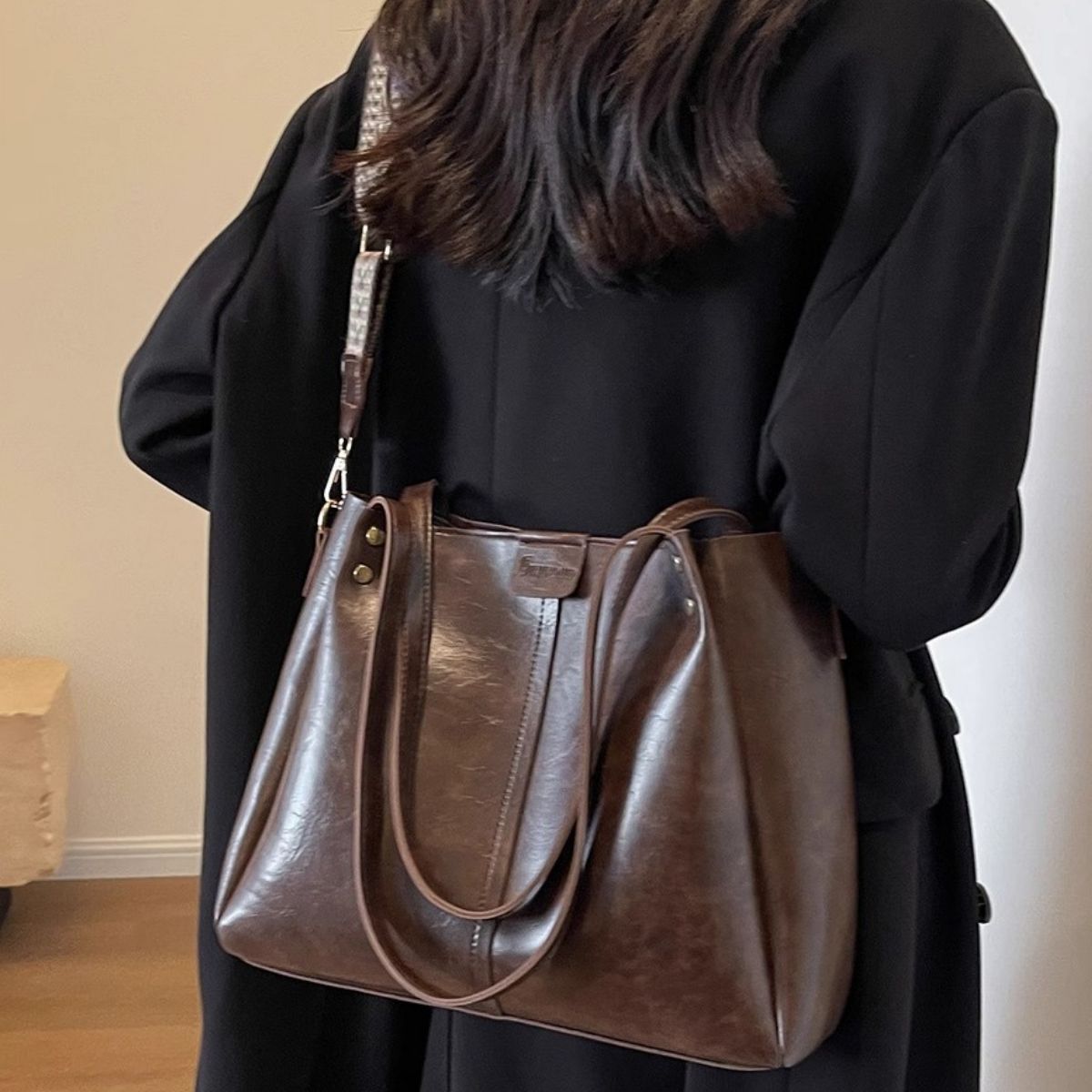 Large distressed brown leather shoulder bag with a detachable strap.