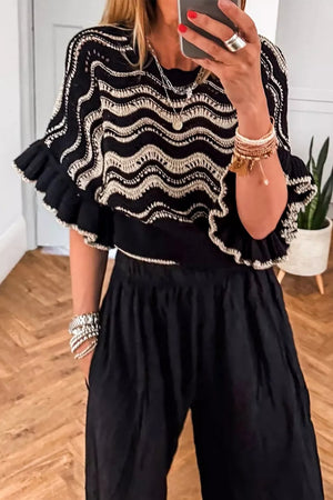 Black openwork knit sweater with cream wavy pattern and ruffled sleeves
