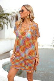 Open-knit caftan with slit hem in a multicolor sunset pattern, V-neck, short sleeves.
