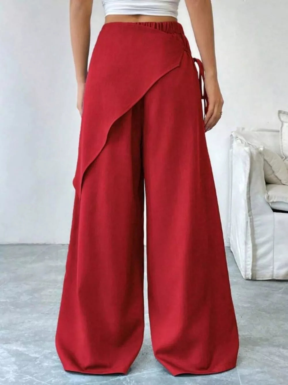 Red maternity wide-leg trousers with a wrap-style front and tie detail.
