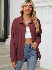 Burgundy corduroy overshirt with patch pockets and button front, styled with a white crop top and jeans.
