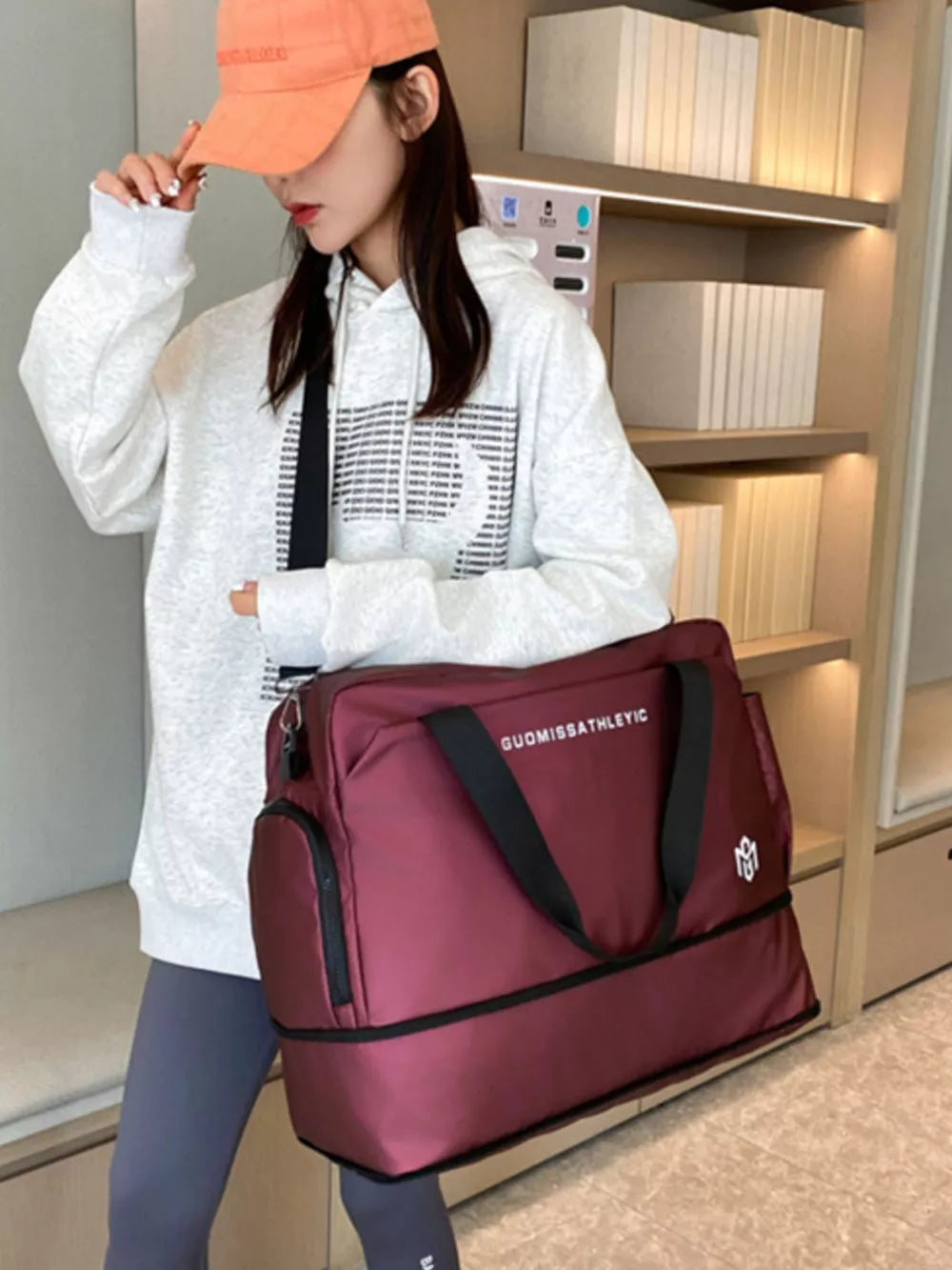 Wine red Oxford cloth travel duffle bag with adjustable strap and side pocket.
