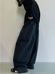 Men's dark grey striped wide-leg sweatpants with pockets, flowy fit.