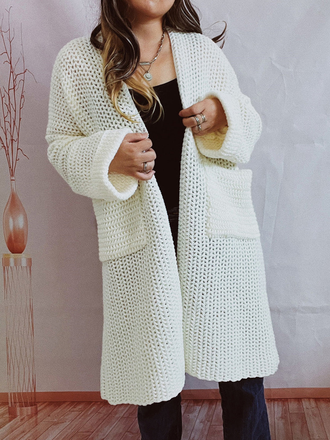 Chunky knit cocoon cardigan coat in white with open front and patch pockets.