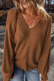 Brown ribbed knit pullover sweater with balloon sleeves and V-neck.