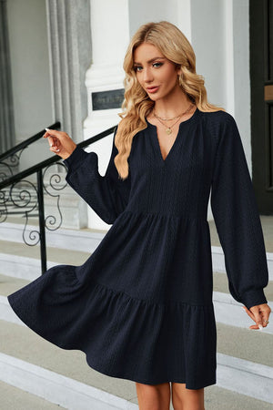 Textured babydoll mini dress in dark blue with voluminous sleeves and tiered hem