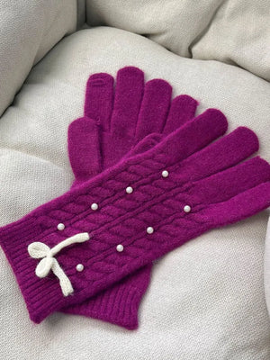 Deep Purple cable knit gloves with pearl embellishments and a white bow detail.