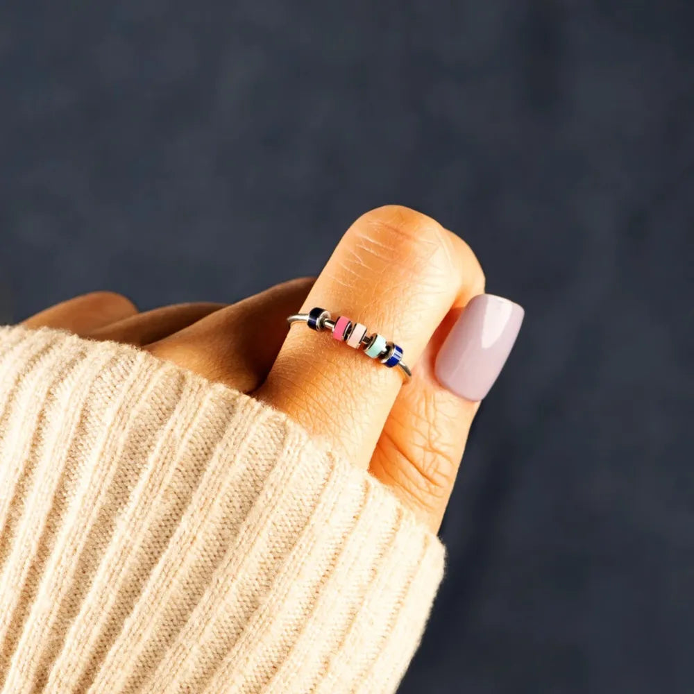 Chromatic bead sterling ring with pink, blue, and white beads.