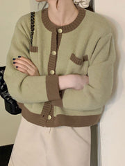 Green acrylic button up cardigan with contrast trim and gold buttons.