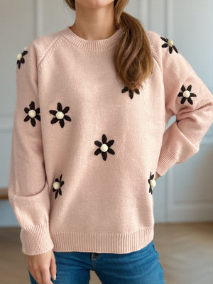 Apricot knit sweater with embroidered floral details and beaded centers.
