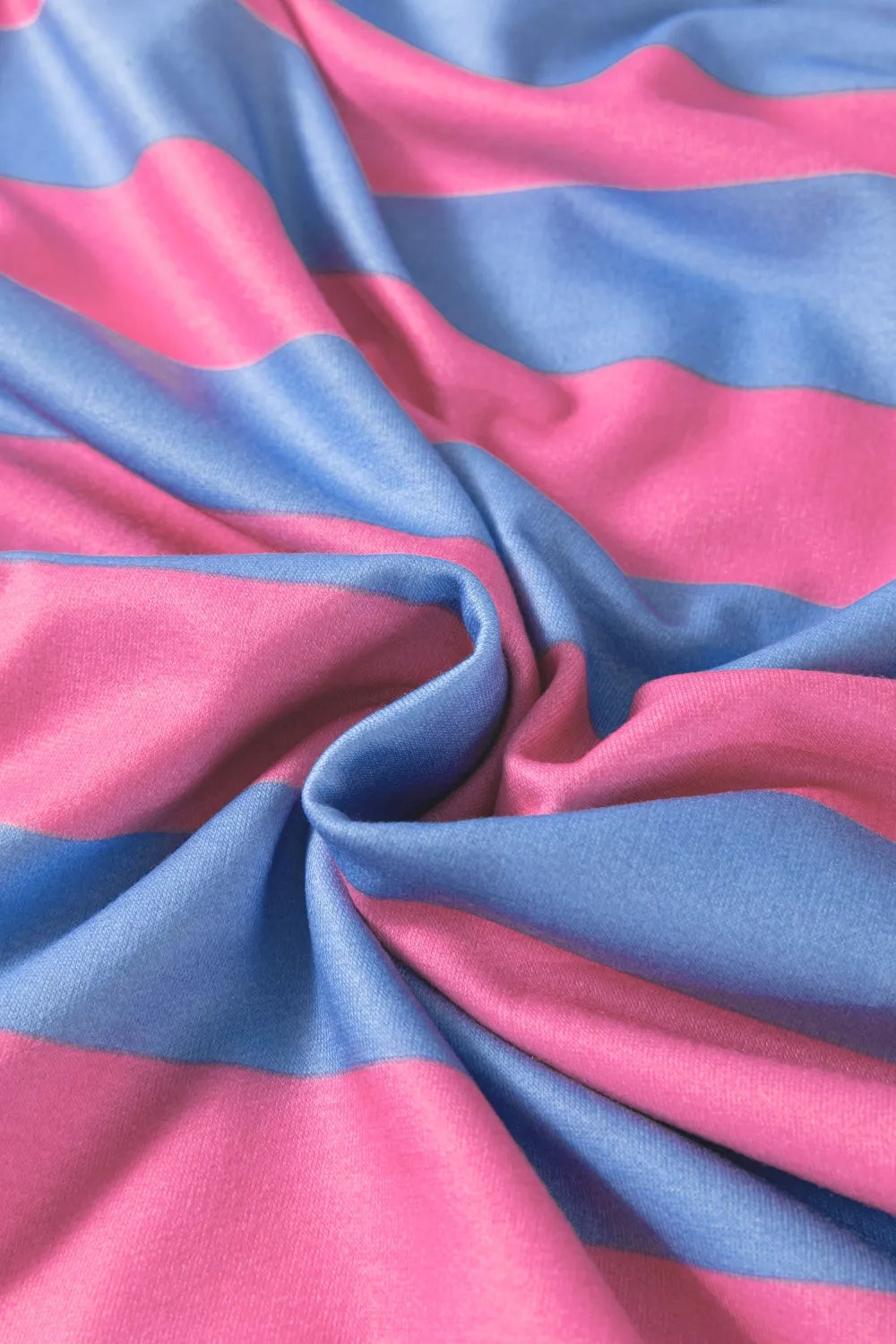 Overshirt with bold pink and blue horizontal stripes and patchwork details.