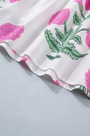 Vibrant floral ruffle mini dress with pink floral print on white fabric, showing ruffled hem detail.