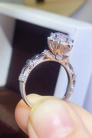 Emerald Bloom Moissanite Halo Ring in sterling silver with diamond accents and rose gold details.