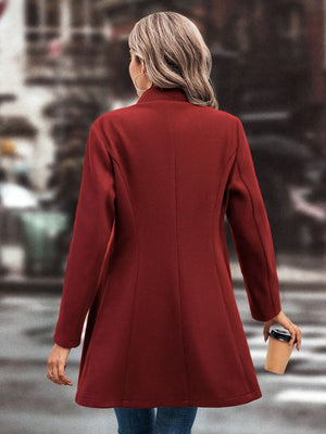 Flared hemline wool coat in deep red with button detail.