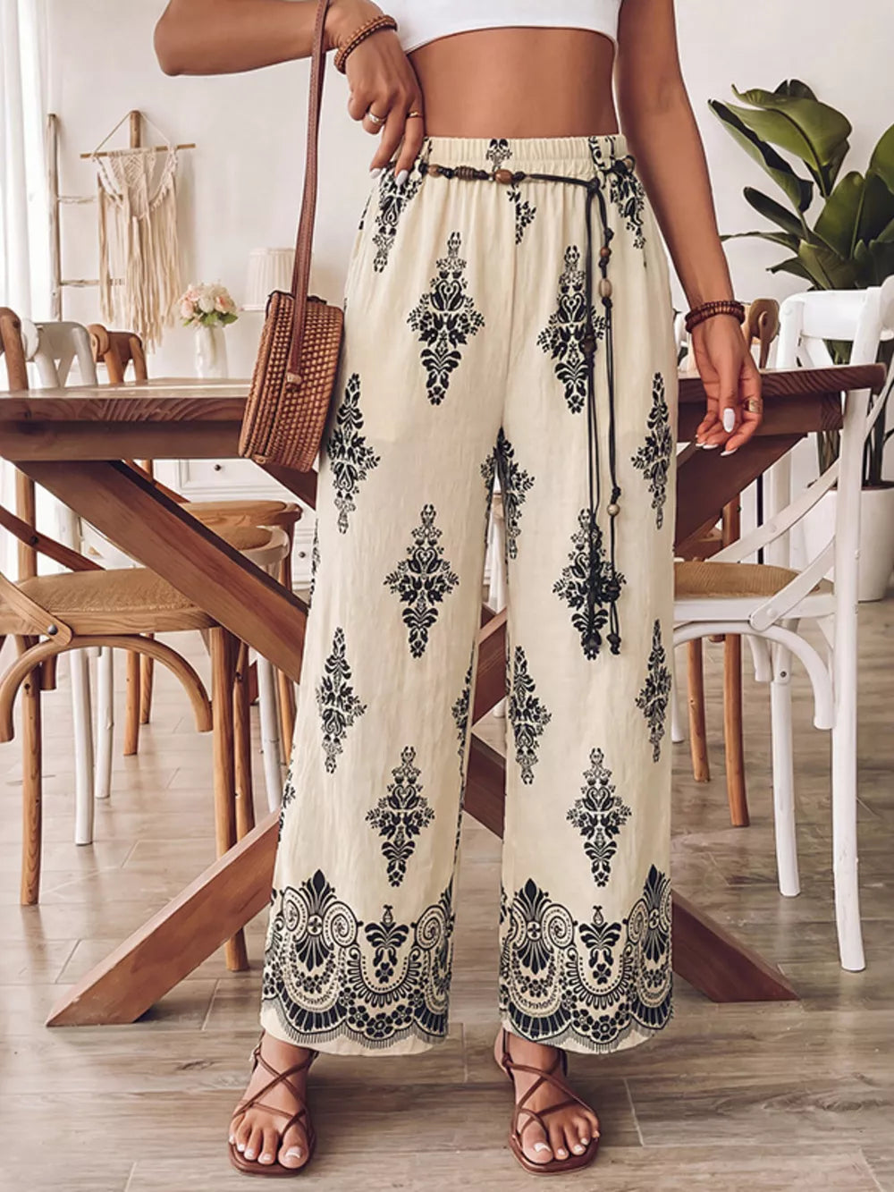 Bohemian wide leg maternity pants in beige with black boho print, featuring a drawstring waist and pockets.