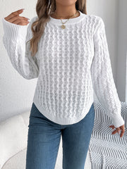 White cable knit sweater with asymmetric hem and crew neck.