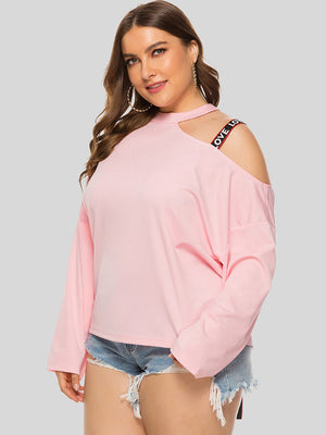 Blush pink sweatshirt with cut-out shoulder and "LOVE" strap detail.