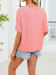 Relaxed fit pink v-neck t-shirt with short sleeves and a layered hem detail.