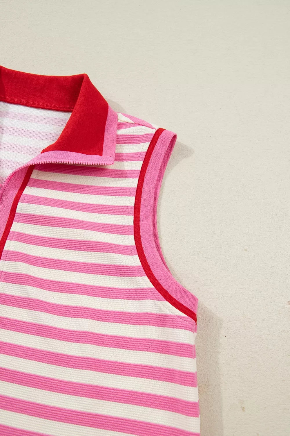 Pink and white striped cotton half-zip polo top with red collar and trim