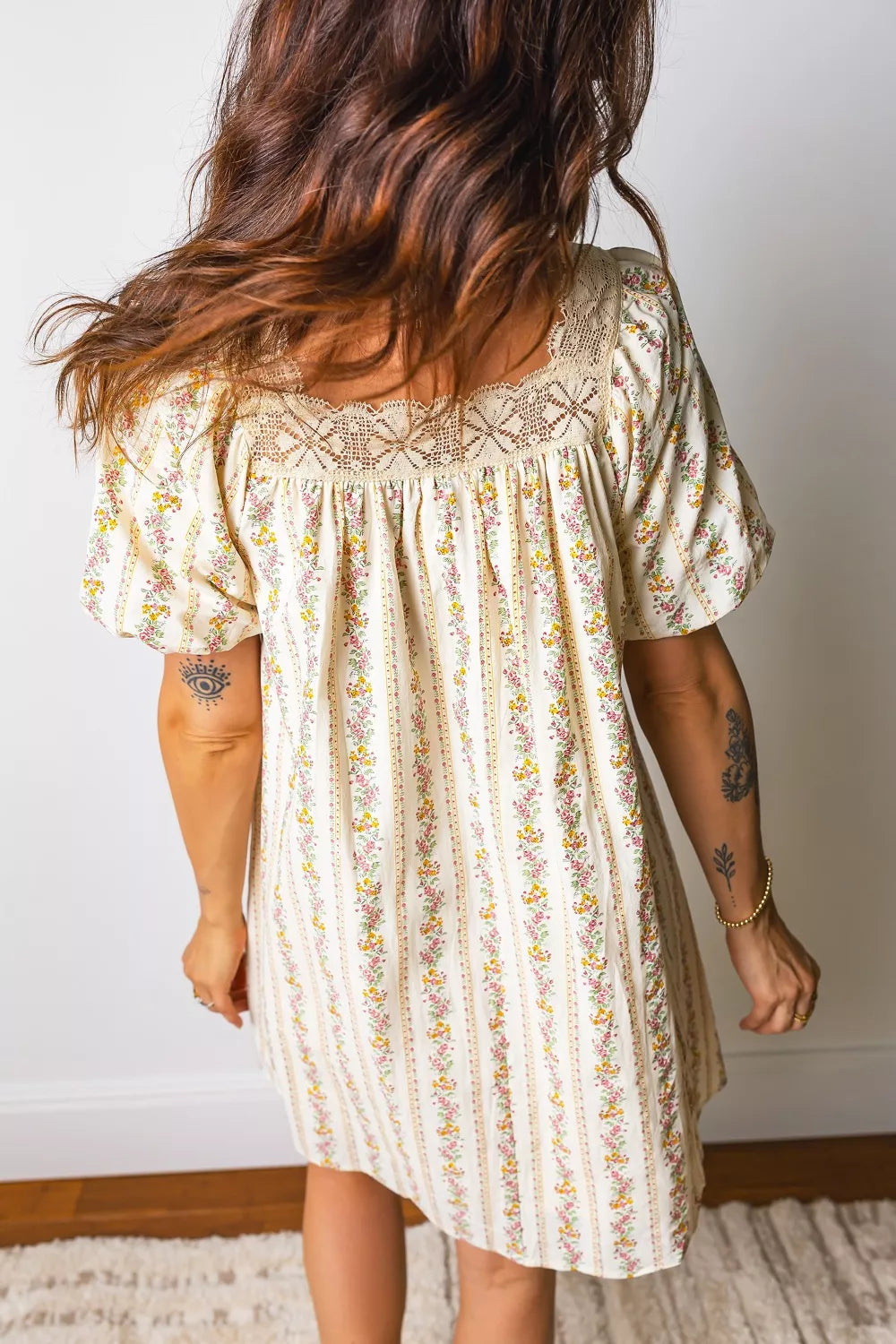 Floral mini dress with lace neckline and short sleeves, featuring a vertical floral stripe pattern.